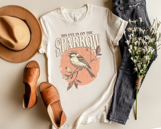 HIS EYE IS ON THE SPARROW ADULT GRAPHIC TEE